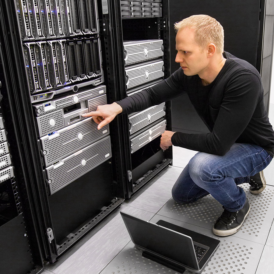 IT Staffing Services. Man looking at server harware