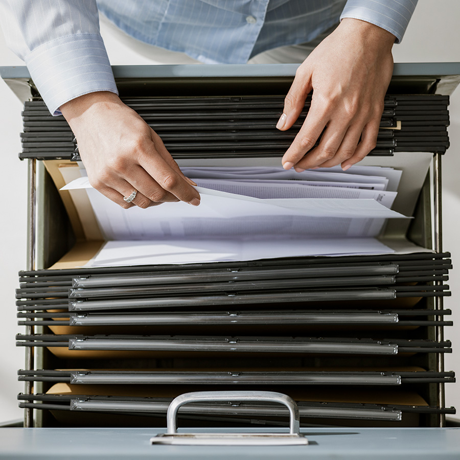 Business document management - worker looking through files